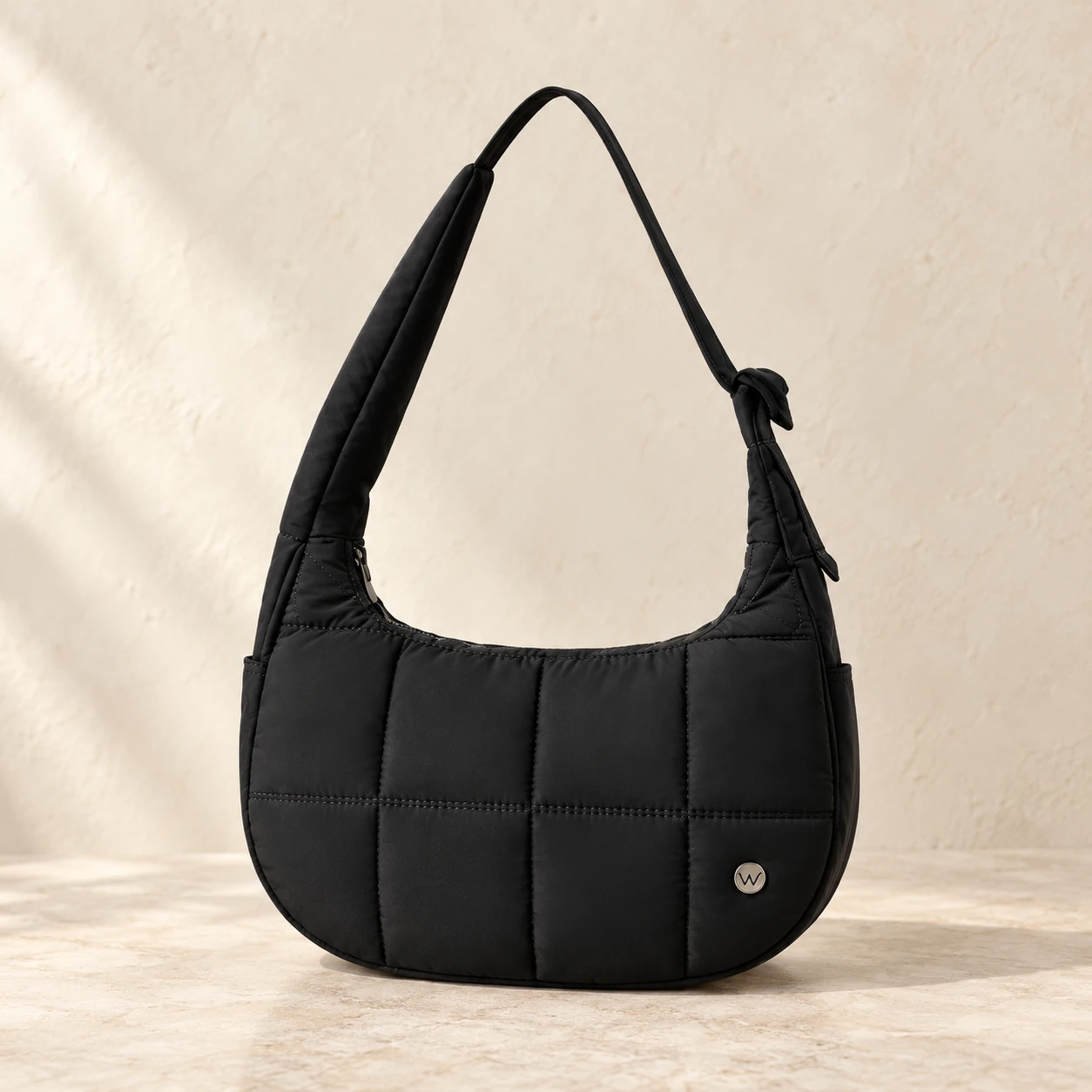 Black WESTBRONCO puffer crescent bag, reference-based illustration